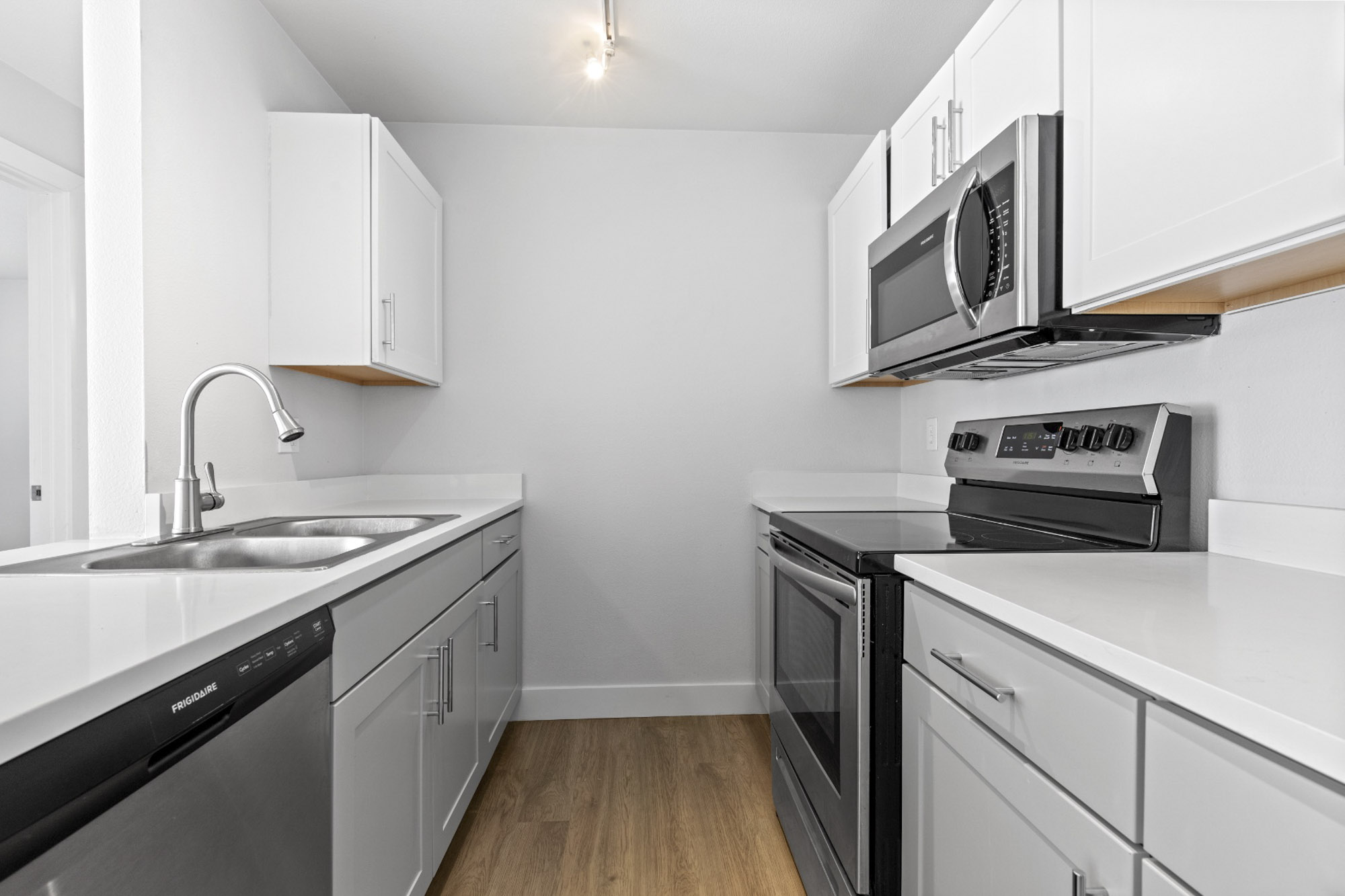 Galley kitchen with stainless steel appliances at The Junction