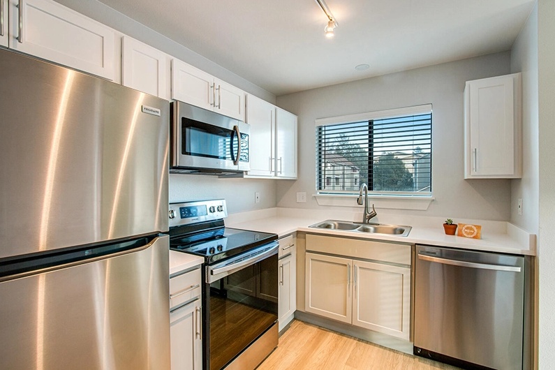 Kitchen with stainless-steel appliances and white cabinetry
