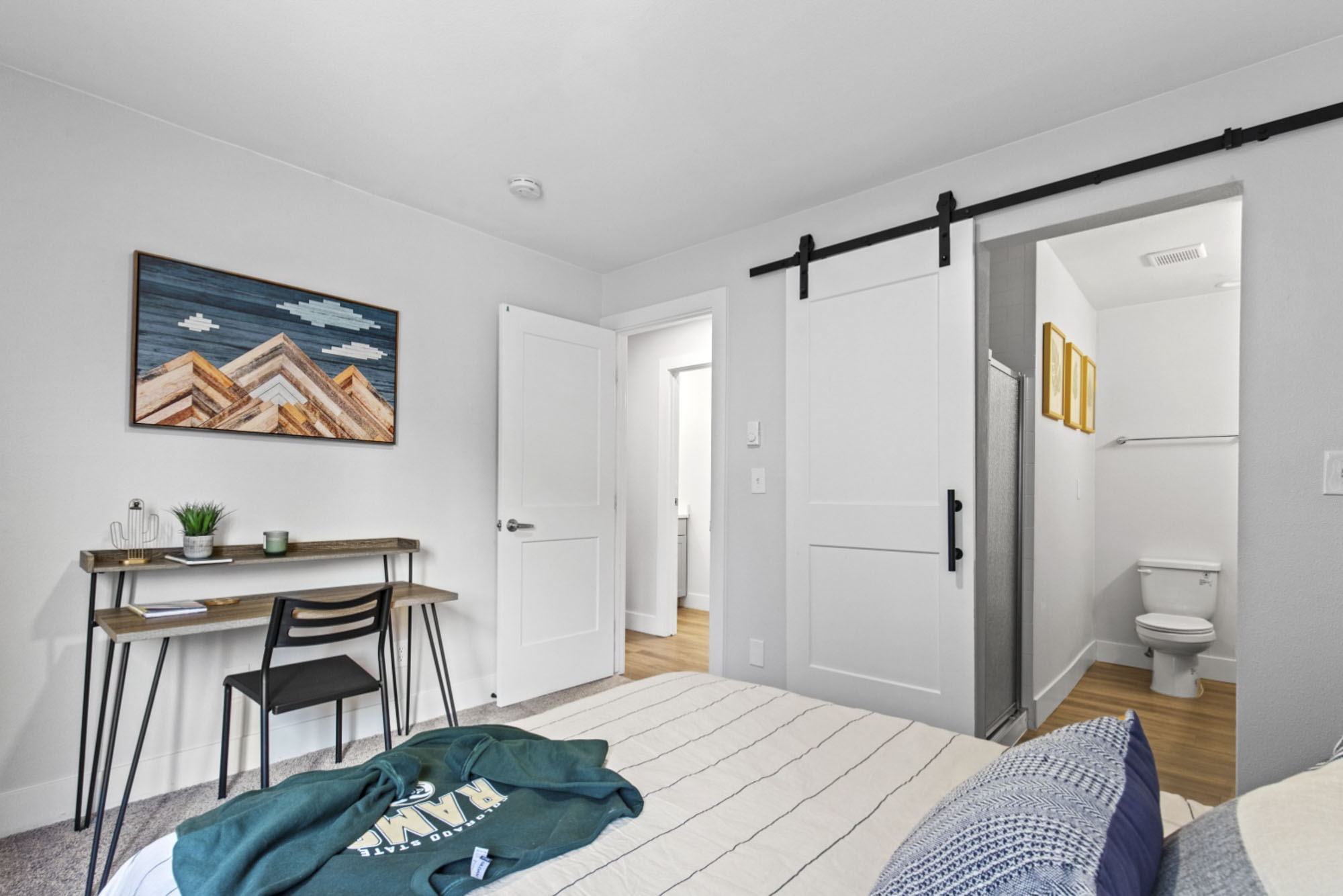 Model bedroom with a desk and private bathroom at The Junction