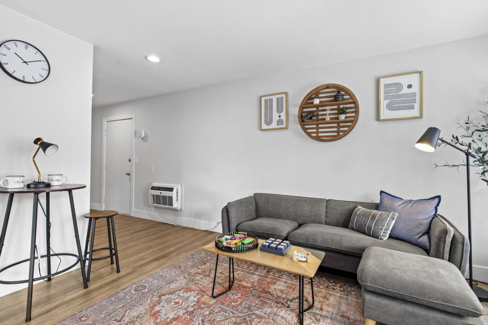 Model living room with hardwood style flooring at The Junction