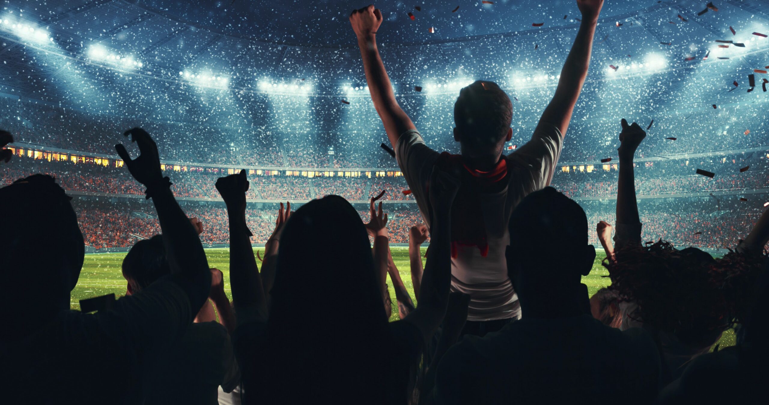 fans celebrating in sports stadium scaled